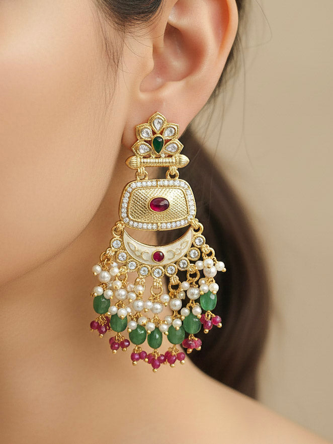 Close-up of a woman wearing an ornate traditional Mint Green Rajwadi gold Long jewellery set and earrings with Pearls, Tumble Beads, Meenakari, Hydro Crystal, Bandhai Work. Woman styled in a royal Rajwadi artificial necklace set for a traditional Indian wedding. Luxury imitation Rajwadi necklace worn for wedding celebrations.