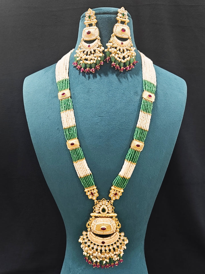 Close-up of an ornate traditional Mint Green Rajwadi gold Long jewellery set and earrings with Pearls, Tumble Beads, Meenakari, Hydro Crystal, Bandhai Work. Reception party look featuring a statement Rajwadi necklace. Luxury imitation Rajwadi necklace worn for wedding celebrations.