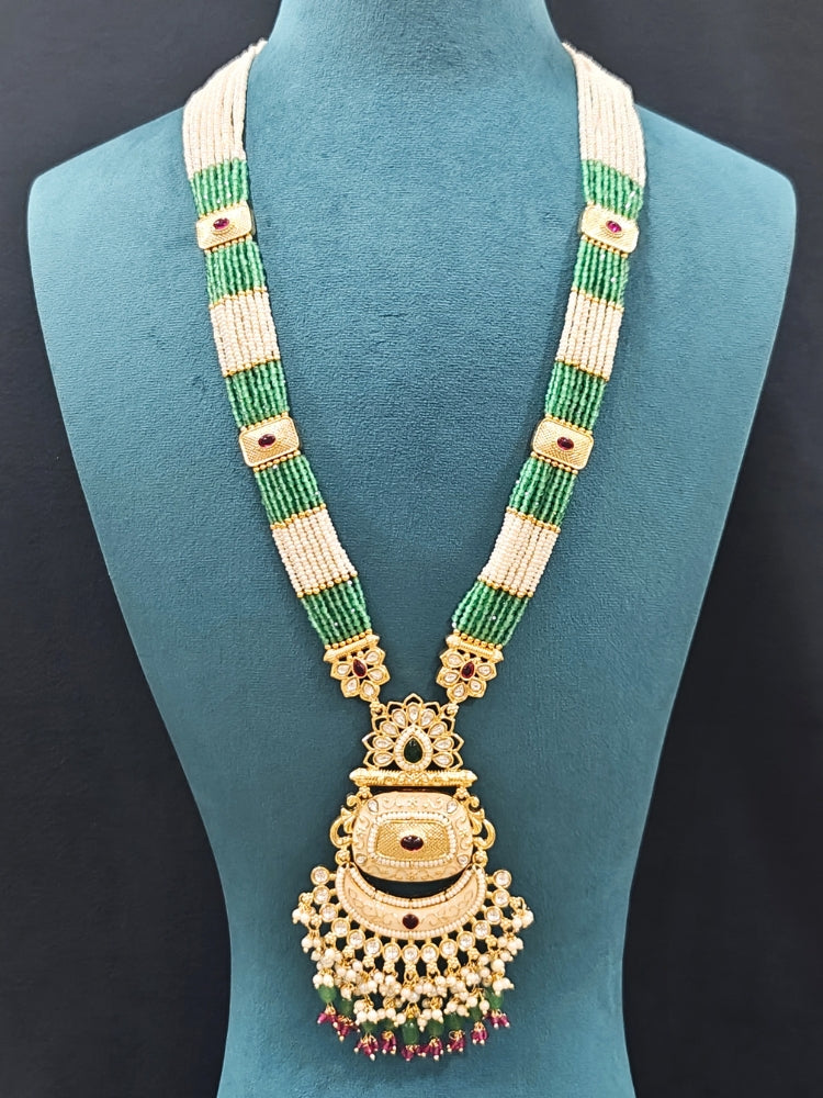 Close-up of an ornate traditional Mint Green Rajwadi gold Long jewellery set and earrings with Pearls, Tumble Beads, Meenakari, Hydro Crystal, Bandhai Work. Reception party look featuring a statement Rajwadi necklace. Luxury imitation Rajwadi necklace worn for wedding celebrations.