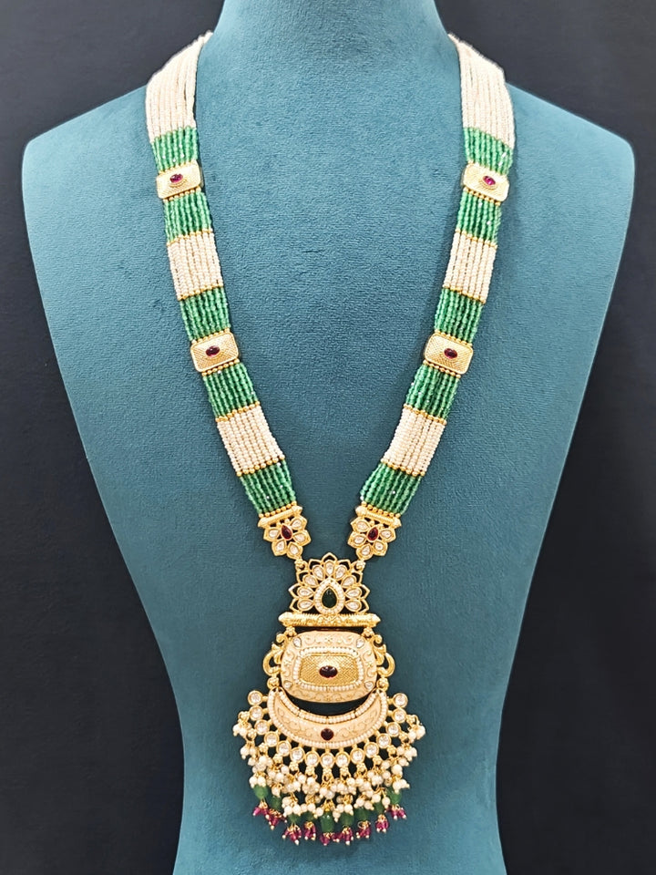 Close-up of an ornate traditional Mint Green Rajwadi gold Long jewellery set and earrings with Pearls, Tumble Beads, Meenakari, Hydro Crystal, Bandhai Work. Reception party look featuring a statement Rajwadi necklace. Luxury imitation Rajwadi necklace worn for wedding celebrations.