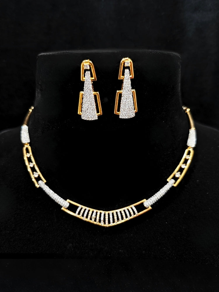 Close-up of an ornate Indo-western gold & White Collar jewellery set and earrings with American Diamond. A luxury American diamond necklace set styled beautifully for a wedding guest look in India. A lightweight American diamond necklace perfect for long wedding functions.