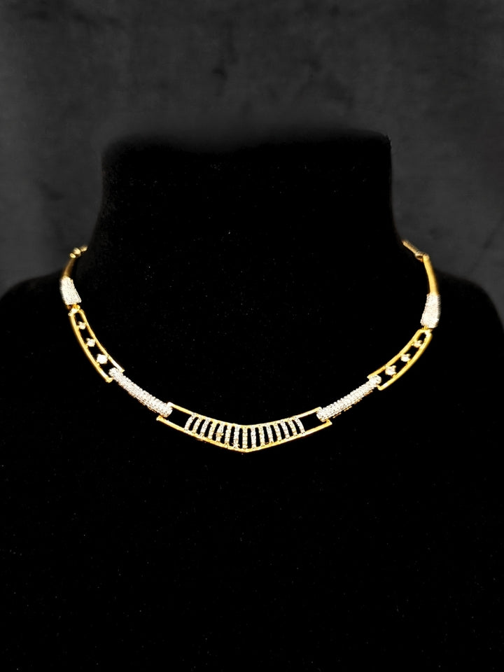 Close-up of an ornate Indo-western gold & White Collar jewellery set and earrings with American Diamond. A luxury American diamond necklace set styled beautifully for a wedding guest look in India. A lightweight American diamond necklace perfect for long wedding functions.