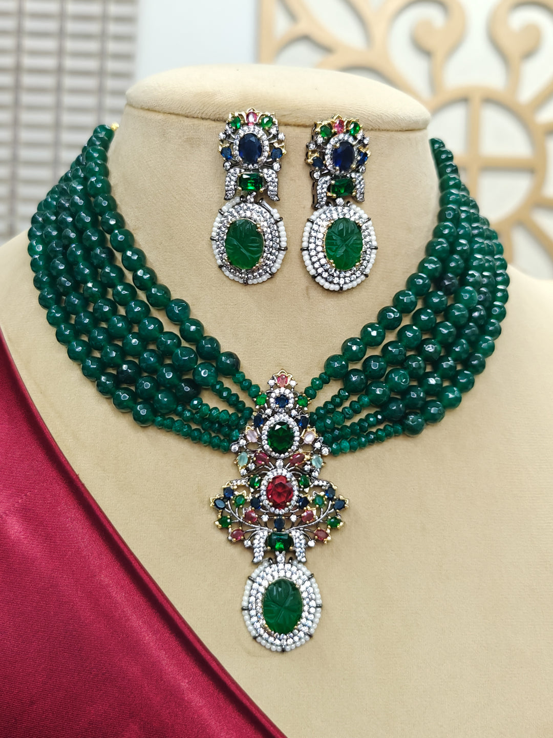 Close-up of an ornate traditional Green Collar jewellery set and earrings with American Diamond, Colored Stones and Green Beads. Mehendi ceremony styling featuring a premium Colored Stones artificial jewelry piece. Close-up of a featuring an anti-tarnish Colored Stones artificial necklace.
