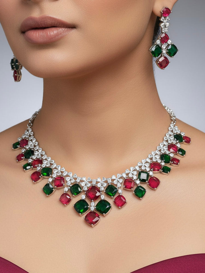 "A bride-to-be wearing an exquisite artificial diamond and red and green colored stone necklace and matching earrings, designed for the perfect engagement look. This stunning artificial diamond jewelry set offers luxury and sophistication while being an affordable alternative to natural diamonds."