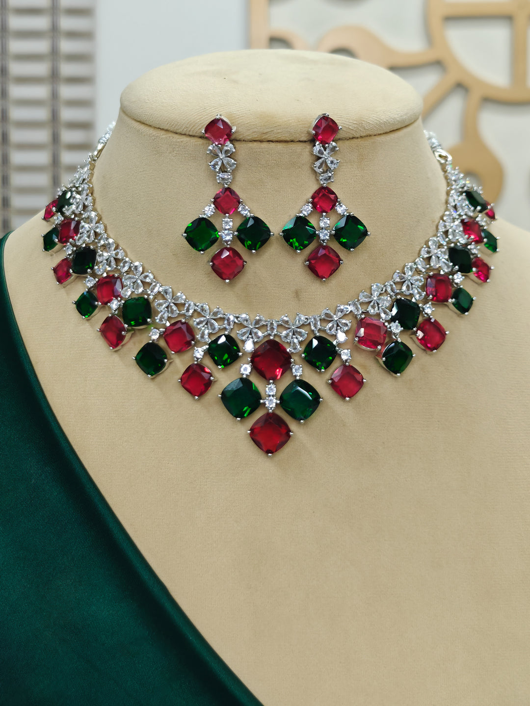 "A woman showcasing a beautiful artificial diamond and red and green colored stone necklace and earrings set, ideal for festivals, family gatherings, and special celebrations in India. This elegant diamond jewelry provides the perfect blend of sparkle and tradition, with a modern twist."
