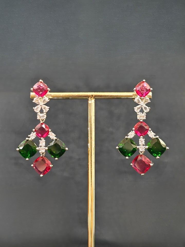An exquisite artificial diamond and red and green colored stone necklace and matching earrings, designed for the perfect engagement look. This stunning artificial diamond jewelry set offers luxury and sophistication while being an affordable alternative to natural diamonds.