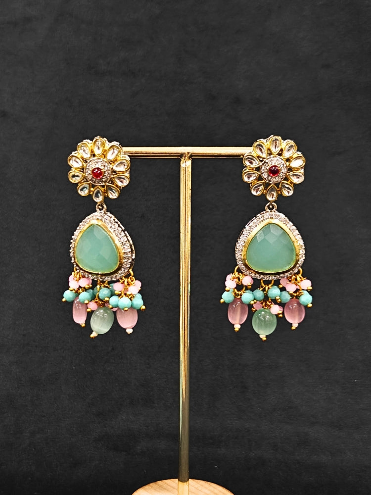Close-up of an ornate traditional Mint Green and Pink Long jewellery set and earrings with American Diamond, Kundan, Tumble & Crystal Beads, Pearls, Tyaani Kundan and Monalisa Stone. A trending Colored Stone artificial jewelry for wedding season in India. Festive saree styling with a premium artificial Colored Stone necklace.
