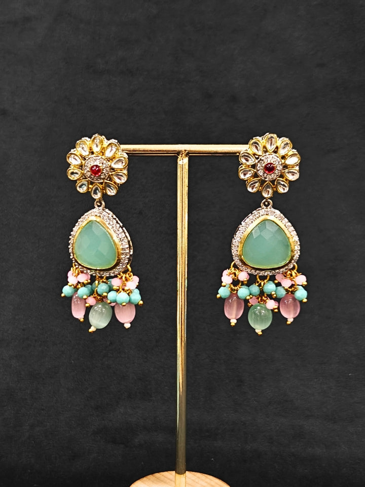 Close-up of an ornate traditional Mint Green and Pink Long jewellery set and earrings with American Diamond, Kundan, Tumble & Crystal Beads, Pearls, Tyaani Kundan and Monalisa Stone. A trending Colored Stone artificial jewelry for wedding season in India. Festive saree styling with a premium artificial Colored Stone necklace.