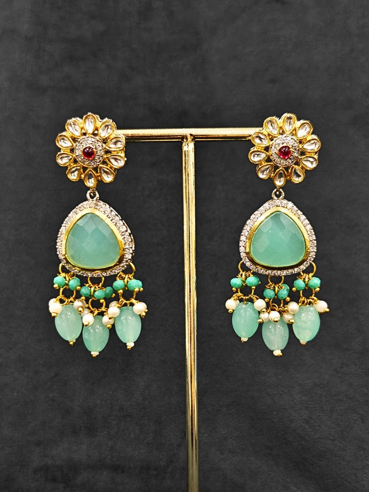 Close-up of  an ornate traditional Sea Green Long jewellery set and earrings with American Diamond, Kundan, Tumble & Crystal Beads, Pearls, Tyaani Kundan and Monalisa Stone. A trending Colored Stone artificial jewelry for wedding season in India. Festive saree styling with a premium artificial Colored Stone necklace.