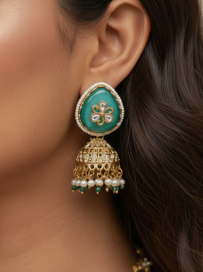 Close-up of a woman wearing an ornate traditional Mint Green Heritage gold Collar jewellery set and earrings with Mint Green Colored Stones, Kundan and Pearls. Woman styling a vintage heritage artificial necklace for a reception party. Perfect  Heritage necklace set for weddings and festivals.