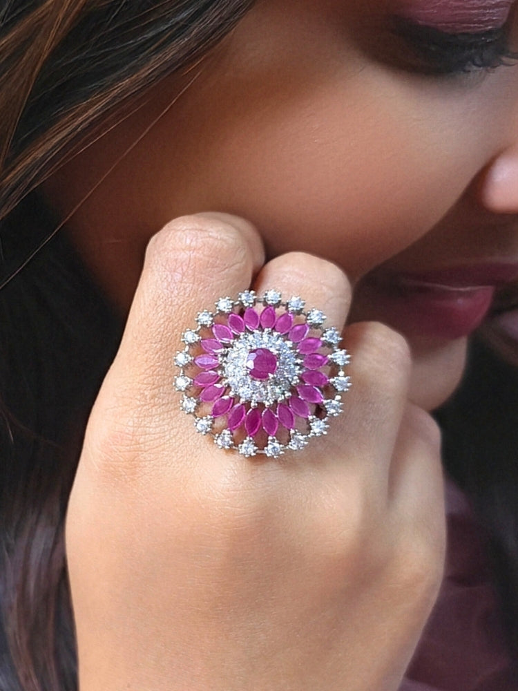 Close-up of a woman wearing an ornate Indo-Western (Silver Polish) Pink Diamond Ring with American Diamond and Pink Colored Stones. Close-up of an American diamond cocktail ring for party wear in India. Wedding guest wearing a statement artificial American Diamond cocktail ring.