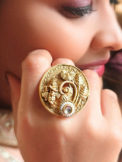A woman wearing the White Akshara Ring featuring a traditional gold Ring with Goddess Krishna, along with Kundan & Pearls. Woman wearing temple artificial Ring for a cultural event in India.