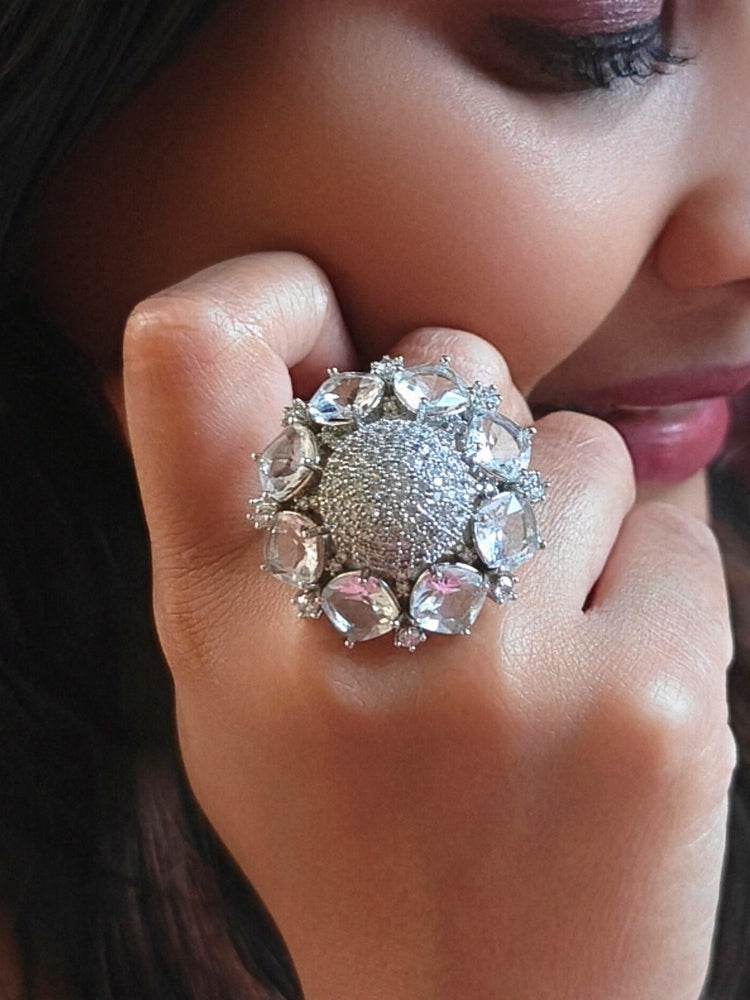Close-up of a woman wearing an ornate Western (Silver Polish) Diamond Ring with American Diamonds. Wedding guest wearing a statement artificial American Diamond cocktail ring. Woman wearing a trendy artificial American Diamond ring for wedding season in India.