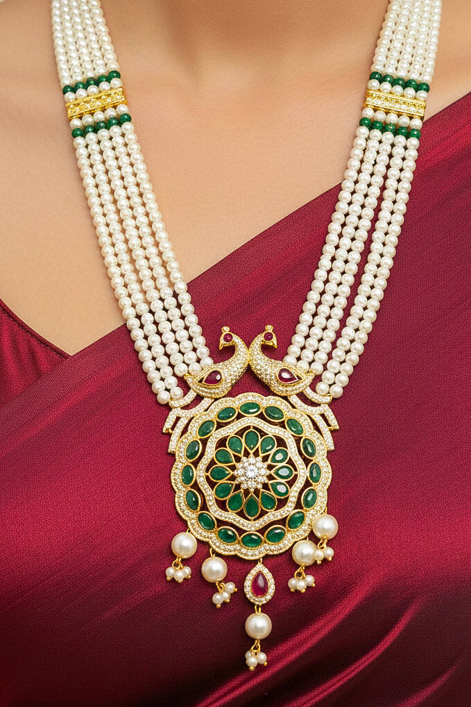 Close-up of a woman wearing an ornate traditional (Gold Polish) White Long Jewellery Set and Earrings with Colored Stones, Pearl and American Dimaonds.  Wedding guest wearing a lightweight Kundan necklace for a Wedding function. Woman wearing trending Pearl artificial jewelry for wedding season in India.