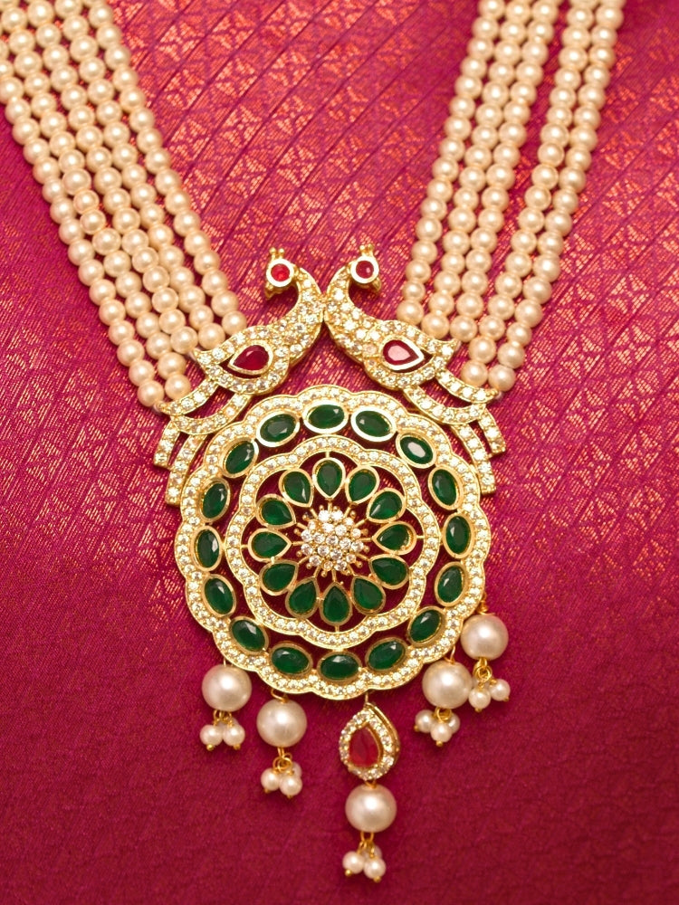 Close-up of a woman wearing an ornate traditional (Gold Polish) White Long Jewellery Set and Earrings with Colored Stones, Pearl and American Dimaonds.  Wedding guest wearing a lightweight Kundan necklace for a Wedding function. Woman wearing trending Pearl artificial jewelry for wedding season in India.