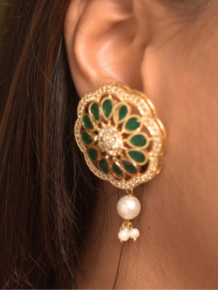 Close-up of a woman wearing an ornate traditional (Gold Polish) White Long Jewellery Set and Earrings with Colored Stones, Pearl and American Dimaonds.  Wedding guest wearing a lightweight Kundan necklace for a Wedding function. Woman wearing trending Pearl artificial jewelry for wedding season in India.