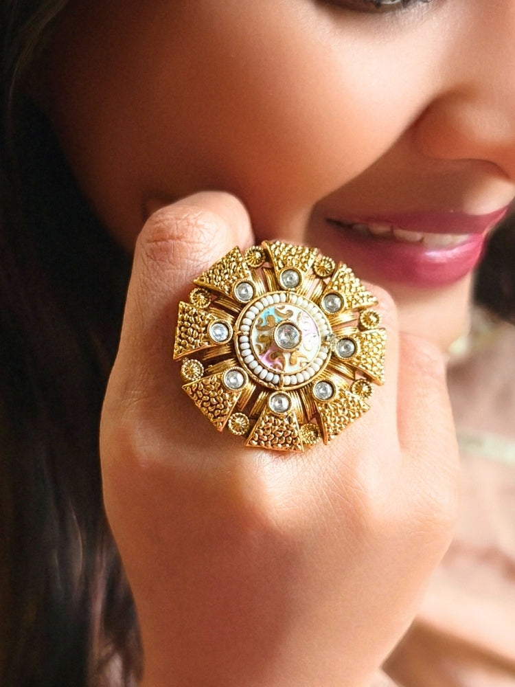 Close-up of a woman wearing an ornate traditional White Meenakari gold Ring with Kundan, Meenakari and Pearls. Wedding guest wearing a statement Meenakari artificial cocktail ring. Perfect Meenakari Ring for weddings and festivals.