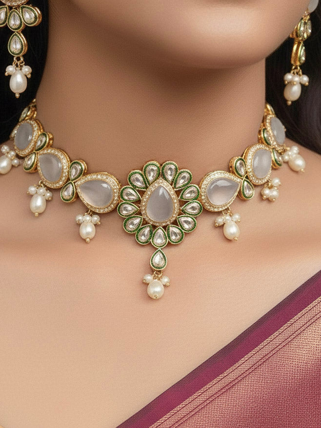 Close-up of a woman wearing an ornate traditional Whitish Grey Choker jewellery set and earrings and maangtikka with Kundan, Monalisa Stone, American Diamonds, Beads and Reverse American Diamonds and tumble stones. A graceful woman wearing a trending Colored Stone necklace for a 2026 wedding celebration. Elegant wedding jewelry look featuring a premium artificial Colored Stone necklace.