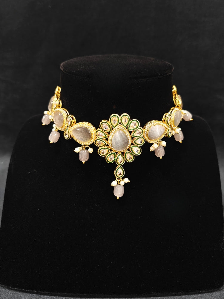 Close-up of an ornate traditional Whitish Grey Choker jewellery set and earrings and maangtikka with Kundan, Monalisa Stone, American Diamonds, Beads and Reverse American Diamonds and tumble stones. A graceful woman wearing a trending Colored Stone necklace for a 2026 wedding celebration. Elegant wedding jewelry look featuring a premium artificial Colored Stone necklace.