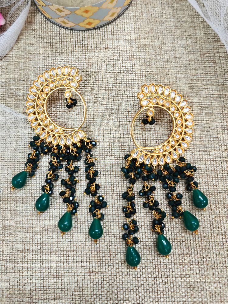 Close-up of an ornate traditional (Gold Polish) Dark Green Long  Earrings with Kundan and Dark Green Beads. Mehendi ceremony look completed with a handcrafted Kundan Earrings. Wedding celebration look enhanced with a statement Kundan Earrings.