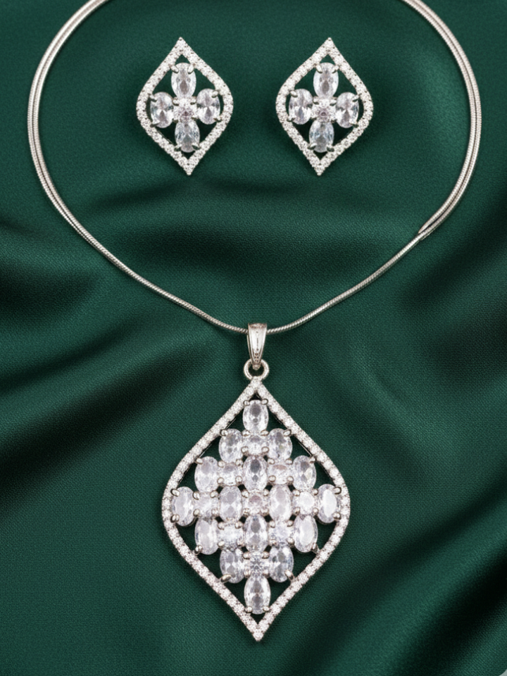 Close-up of a woman wearing an ornate Western (Silver Polish) Diamond Pendant Set with American Diamond. Close-up of a cocktail party look featuring a premium American diamond Pendant. Party wear outfit completed with a lightweight American diamond Pendant.