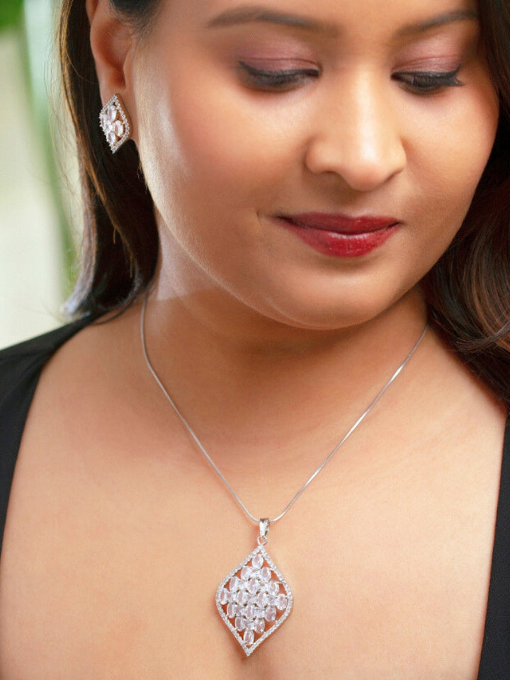 Close-up of a woman wearing an ornate Western (Silver Polish) Diamond Pendant Set with American Diamond. Close-up of a cocktail party look featuring a premium American diamond Pendant. Party wear outfit completed with a lightweight American diamond Pendant.
