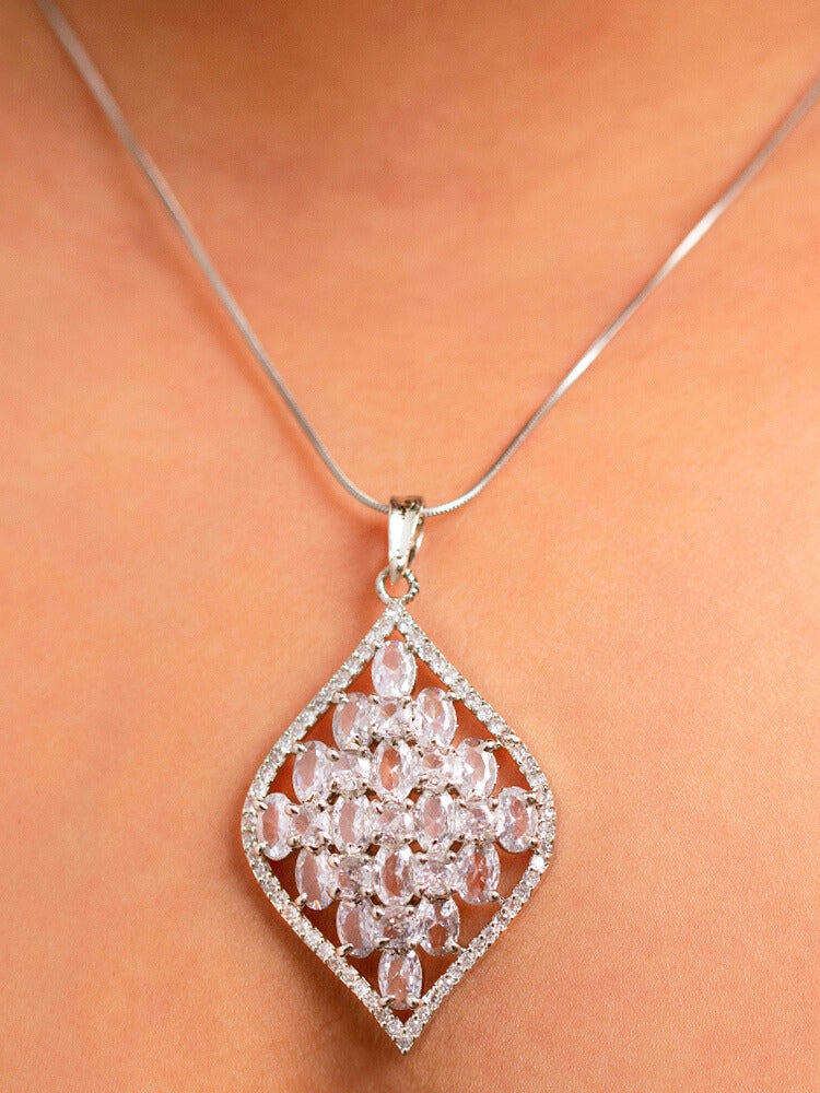 Close-up of a woman wearing an ornate Western (Silver Polish) Diamond Pendant Set with American Diamond. Close-up of a cocktail party look featuring a premium American diamond Pendant. Party wear outfit completed with a lightweight American diamond Pendant.