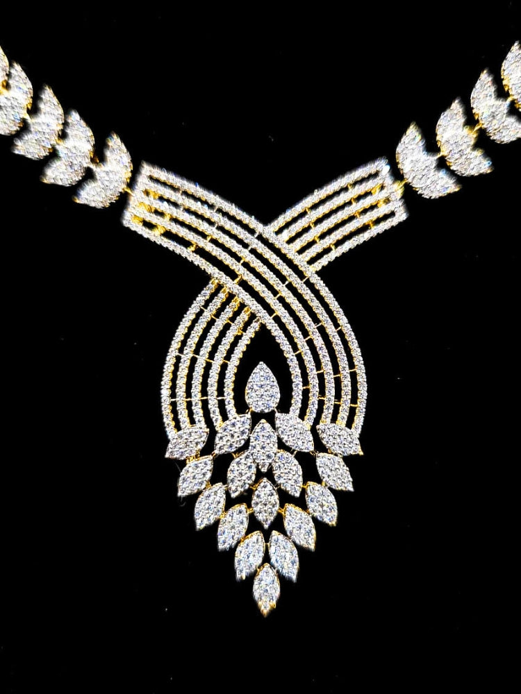 Close-up of an ornate Western American Diamond Gold Collar jewellery set and earrings with American Diamond. Close-up of a featuring an anti-tarnish American diamond artificial necklace. A luxury American diamond necklace set styled beautifully for a wedding guest look in India.