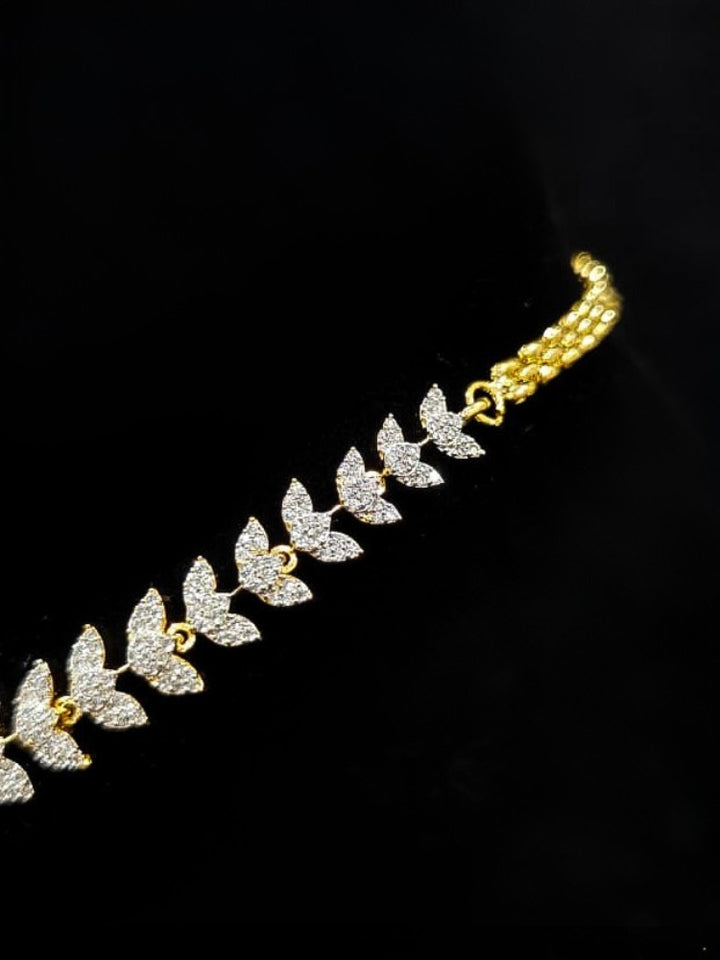 Close-up of an ornate Western American Diamond Gold Collar jewellery set and earrings with American Diamond. Close-up of a featuring an anti-tarnish American diamond artificial necklace. A luxury American diamond necklace set styled beautifully for a wedding guest look in India.