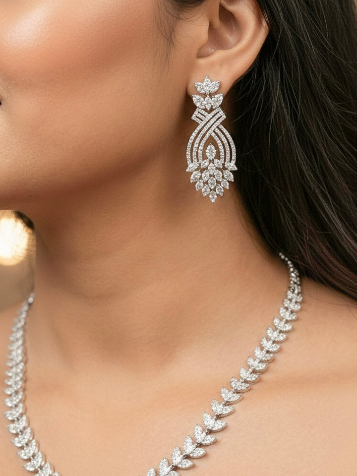 "Close-up of a woman wearing a sparkling artificial diamond necklace and diamond earrings set, designed to offer a radiant, elegant look for any formal occasion or Indian wedding. This affordable diamond jewelry provides a flawless, luxurious alternative to natural diamonds."
