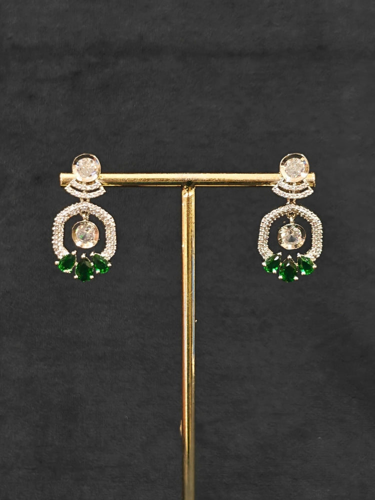 Close-up of an ornate Indo-western Green (Silver Polish) Collar jewellery set and earrings with American Diamond and Colored Stones. Elegant festive look with a high-quality imitation American diamond necklace set. Party wear outfit completed with a lightweight American diamond necklace.