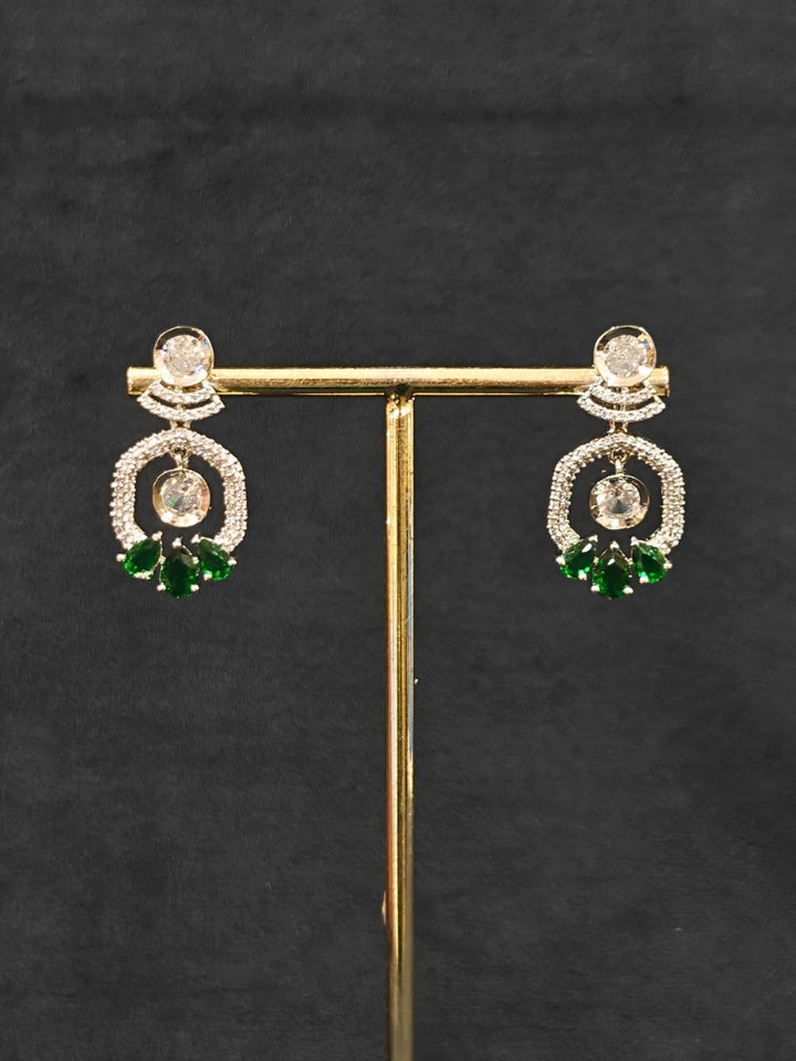 Close-up of an ornate Indo-western Green (Silver Polish) Collar jewellery set and earrings with American Diamond and Colored Stones. Elegant festive look with a high-quality imitation American diamond necklace set. Party wear outfit completed with a lightweight American diamond necklace.