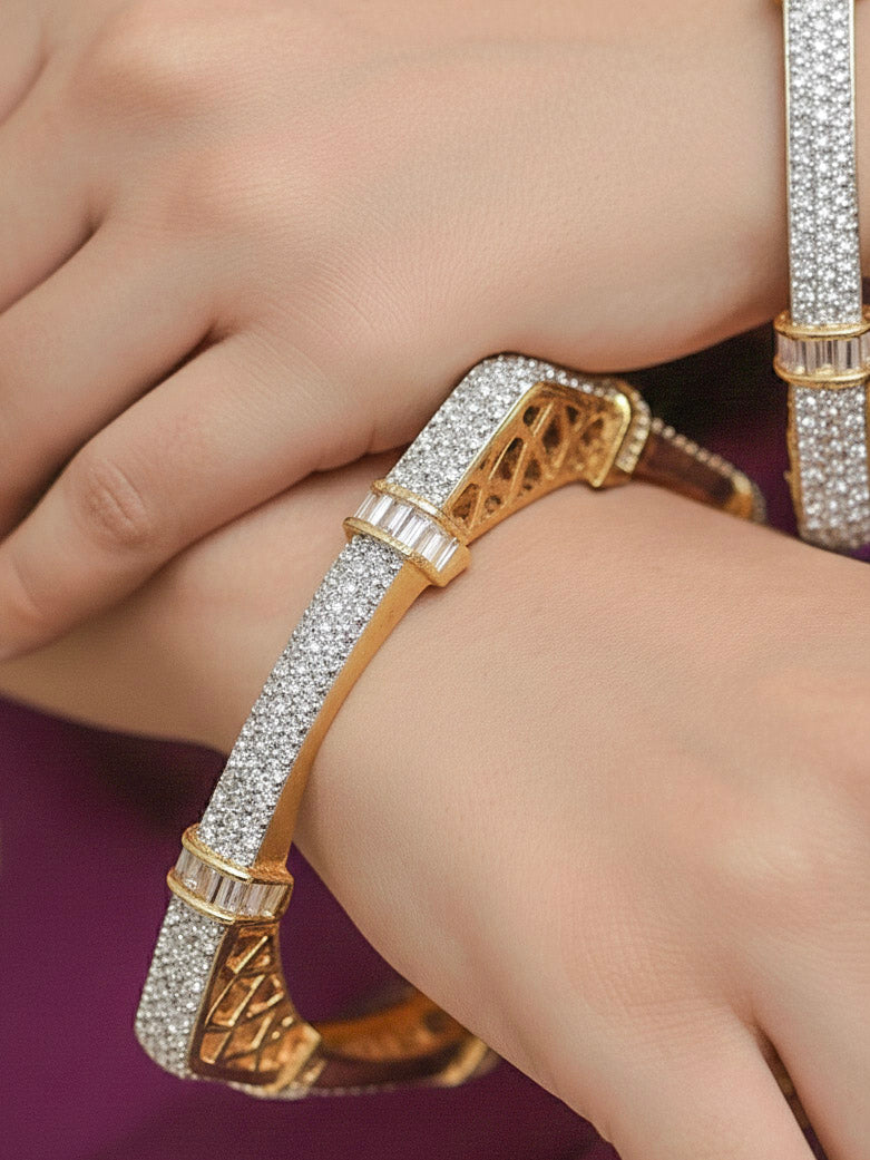Close-up of a woman wearing an ornate Indo-western White Diamond (gold Polish) Bangles with American Diamond and Filigree Work. Reception party outfit styled with premium wedding American Diamond bangles. Saree look enhanced with handcrafted artificial American Diamond bangles.