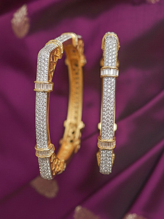 Close-up of a woman wearing an ornate Indo-western White Diamond (gold Polish) Bangles with American Diamond and Filigree Work. Reception party outfit styled with premium wedding American Diamond bangles. Saree look enhanced with handcrafted artificial American Diamond bangles.