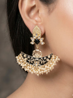 Close-up of a woman wearing an ornate traditional Black Meenakari gold Earrings with Pearls, Kundan and Meenakari. Reception party styling featuring a premium Meenakari imitation Earring. Perfect Earrings for weddings and festivals.