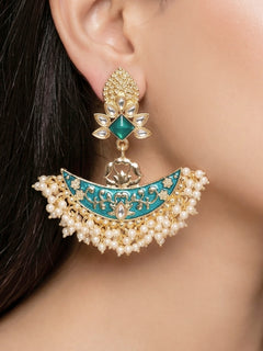Close-up of a woman wearing an ornate traditional Blue Meenakari gold Earrings with Pearls, Kundan and Meenakari. Mehendi ceremony look completed with a handcrafted Meenakari Earrings. Wedding guest wearing a lightweight Meenakari artificial Earrings.
