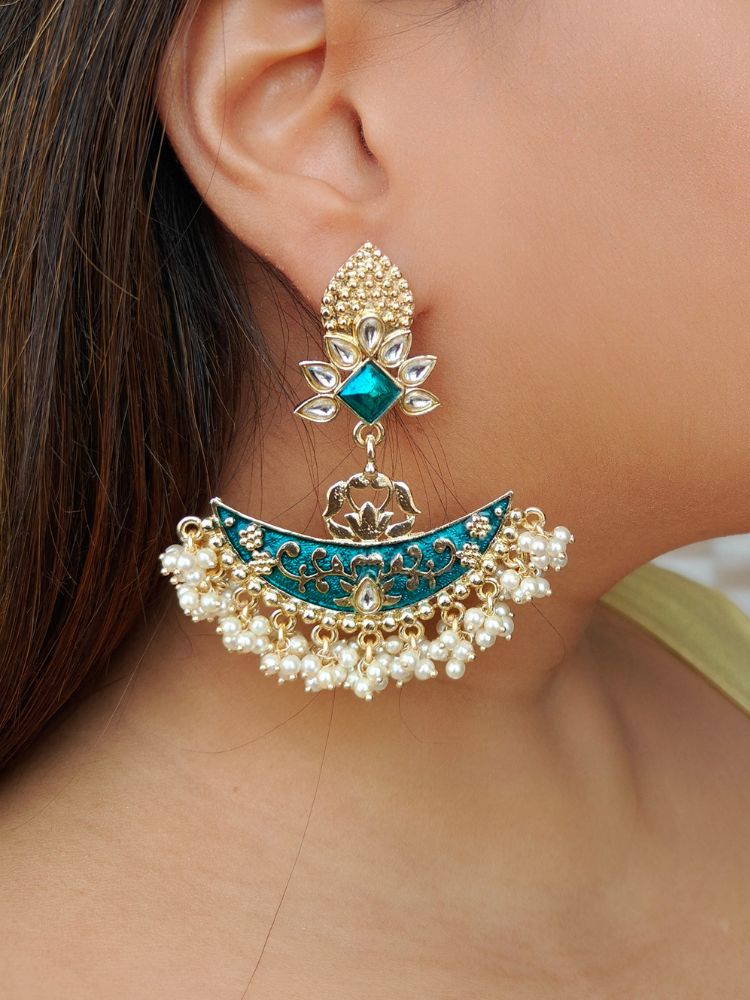 Close-up of a woman wearing an ornate traditional Blue Meenakari gold Earrings with Pearls, Kundan and Meenakari. Mehendi ceremony look completed with a handcrafted Meenakari Earrings. Wedding guest wearing a lightweight Meenakari artificial Earrings.
