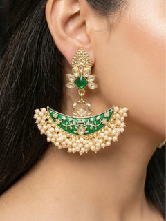Close-up of a woman wearing an ornate traditional Green Meenakari gold Earrings with Pearls, Kundan and Meenakari. Mehendi ceremony look completed with a handcrafted Meenakari Earrings. Woman wearing a vibrant Meenakari artificial Earrings for celebrations.