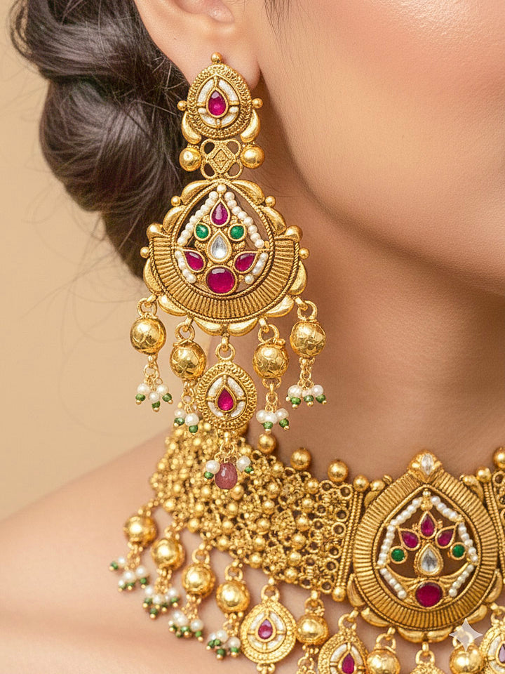 Close-up of an ornate traditional (Bright Gold Polish) Choker jewellery set and earrings with Pearl and Colored Stone. Woman wearing a vibrant Colored Stone artificial jewelry set for celebrations. Wedding function styling with a premium Colored Stone imitation necklace.