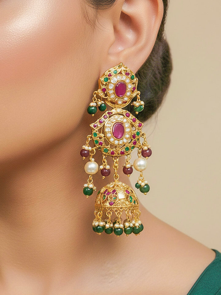 Close-up of a woman wearing an ornate traditional Choker jadau gold jewellery set and  jadau earrings with crystals beads and gemstones. Perfect Jadau necklace set for weddings and festivals. Bride showcasing a royal Jadau necklace set in India.
