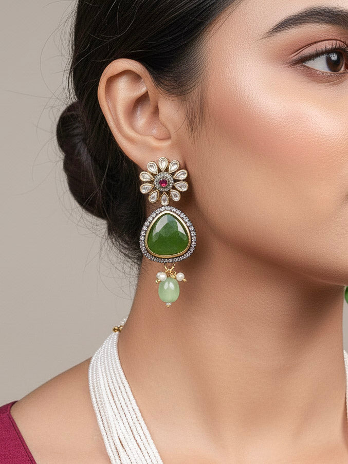 Close-up of a woman wearing an ornate traditional (Black Polish) Mehendi Green long jewellery set and earrings with Mehendi Green Colored Stones, Tumble Beads, Pearls and American Diamond. Woman wearing trending Colored Stone artificial jewelry for wedding season in India. Festive celebration look enhanced with traditional Colored Stone jewelry.