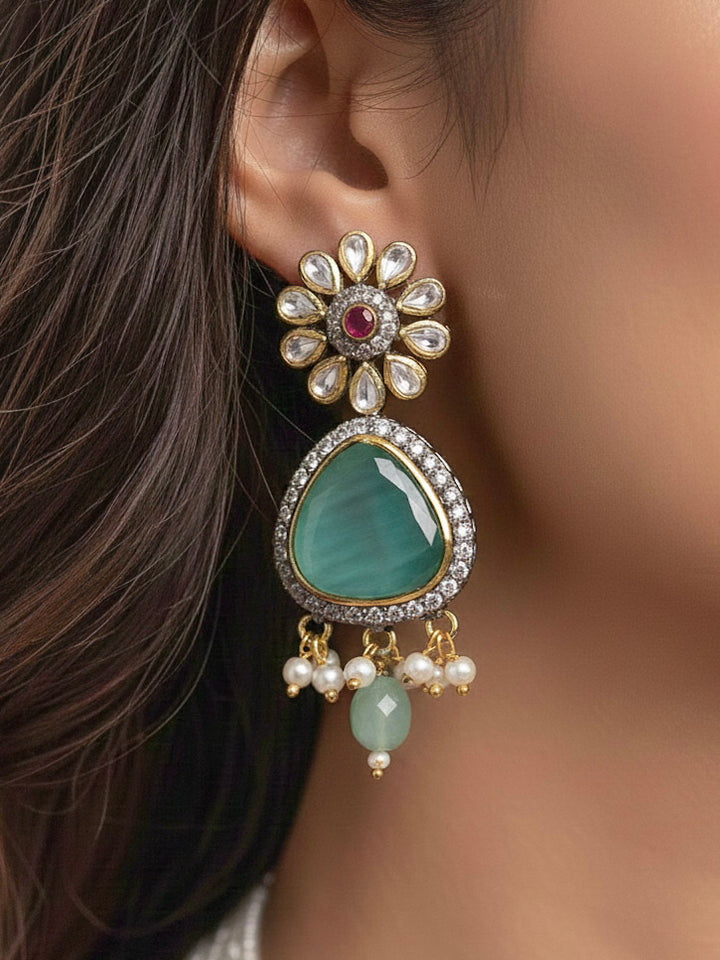 Close-up of a woman wearing an ornate traditional (Black Polish) Sea Green long jewellery set and earrings with Sea Green Colored Stones, Tumble Beads, Pearls and American Diamond. Woman wearing trending Colored Stone artificial jewelry for wedding season in India. Festive celebration look enhanced with traditional Colored Stone jewelry.