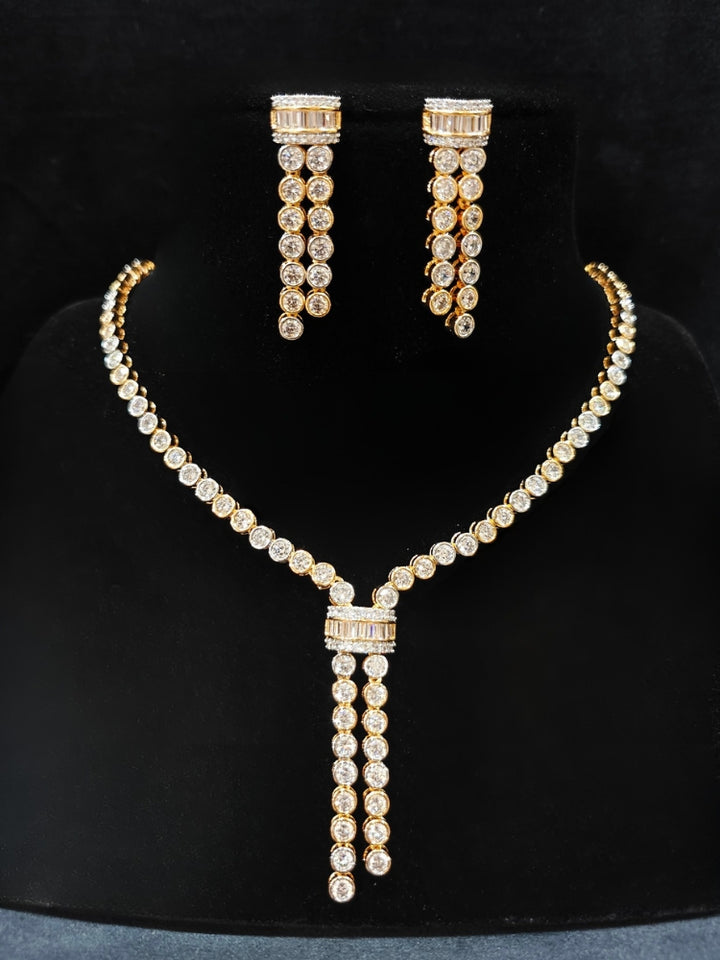 Close-up of an ornate Western Diamond gold Collar jewellery set and earrings with American Diamond. A trending American diamond necklace for a 2026 Reception celebration. Close-up of a cocktail party look featuring a premium American diamond necklace.