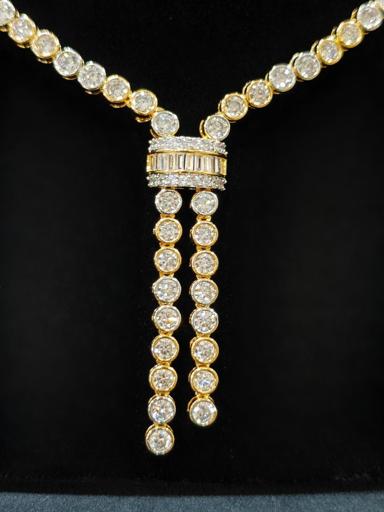 Close-up of an ornate Western Diamond gold Collar jewellery set and earrings with American Diamond. A trending American diamond necklace for a 2026 Reception celebration. Close-up of a cocktail party look featuring a premium American diamond necklace.