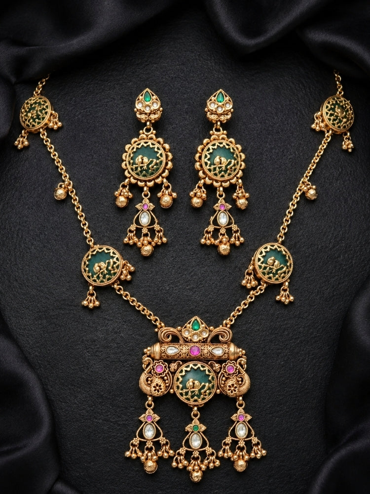 Green bird-motif Heritage necklace set with matching earrings on black satin