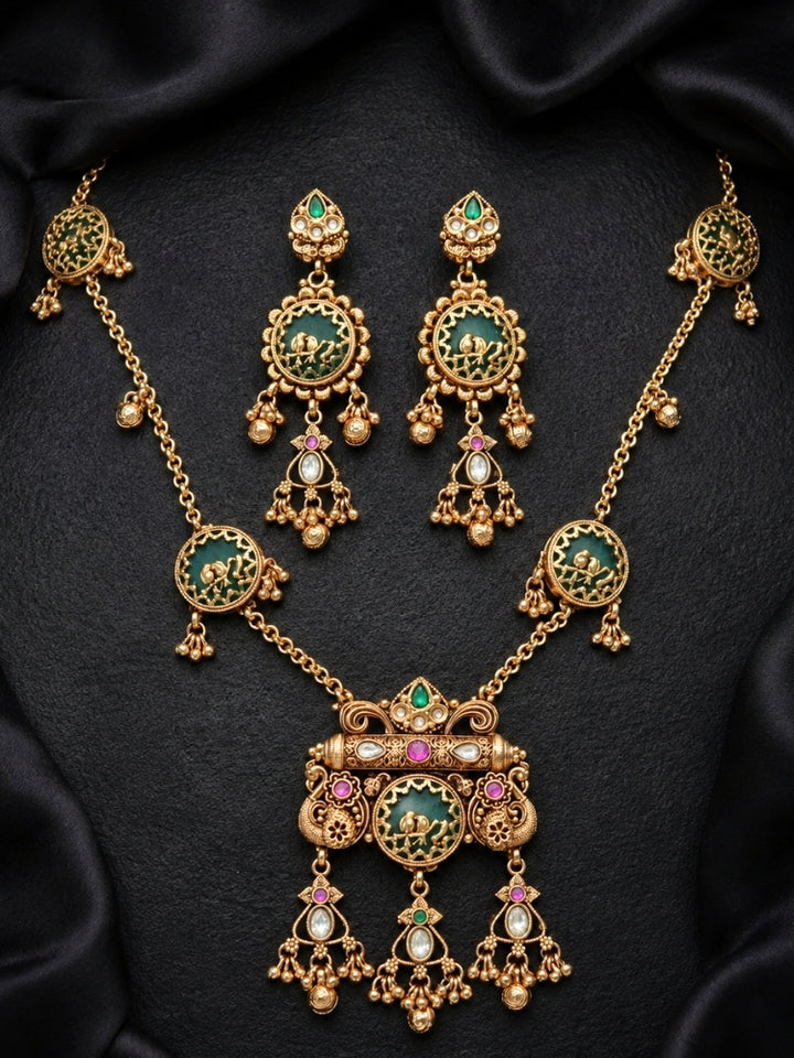 Green bird-motif Heritage necklace set with matching earrings on black satin