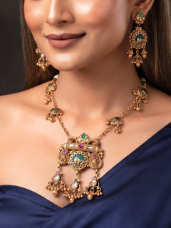 Woman wearing medium-length antique gold Heritage necklace with navy blue saree